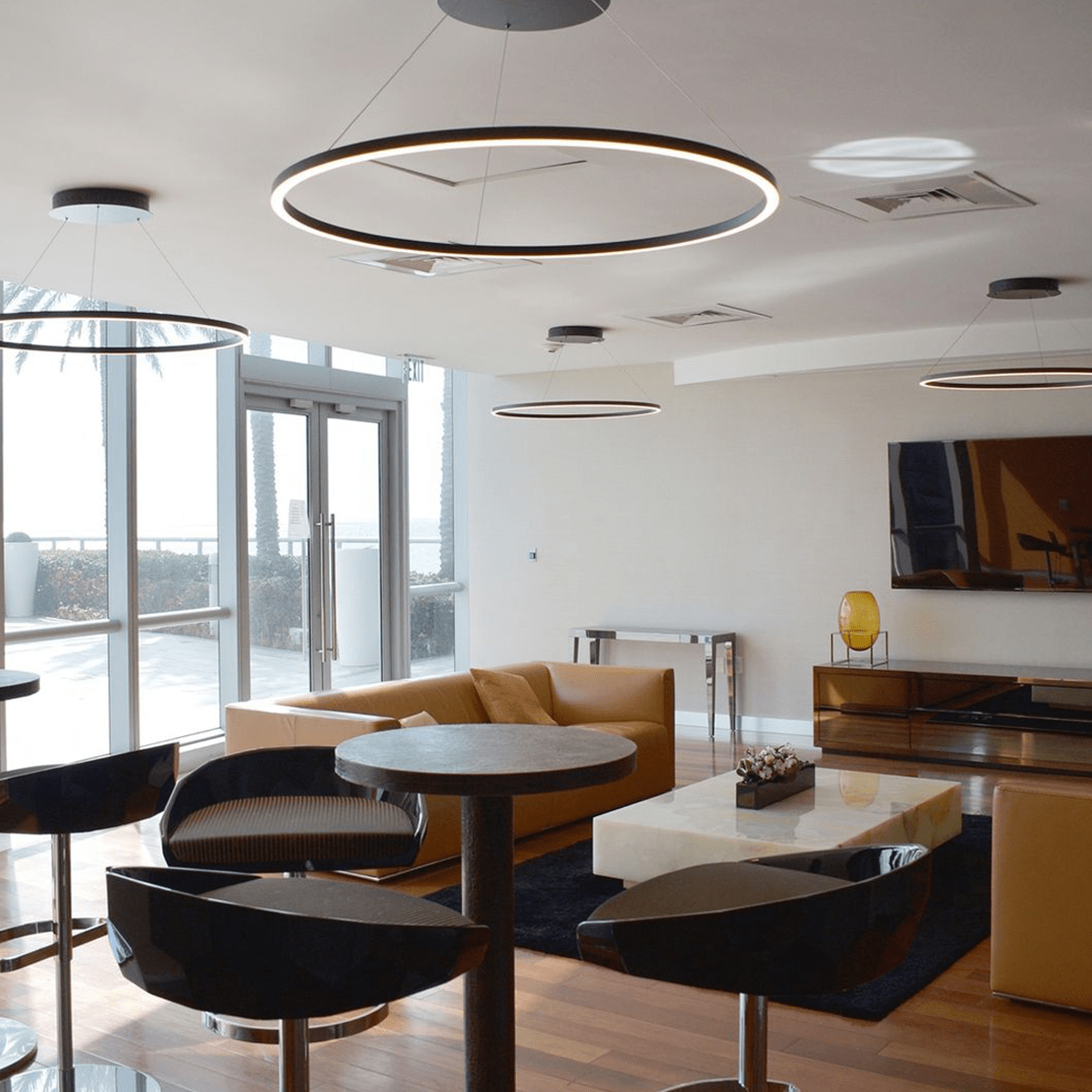 Multiple large curva halo LED Pendant ceiling lights installed in a modern interor.