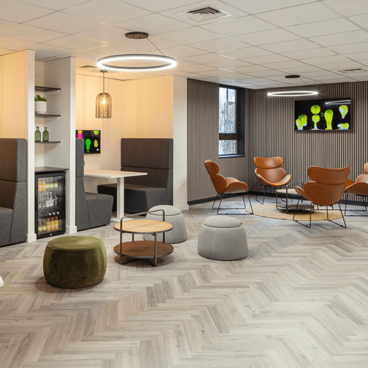 Modern circular LED ceiling lights installed in a breakout room.