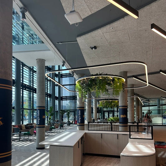 Modern interior of a building with a reception desk and glass walls and rounded rectangle led light