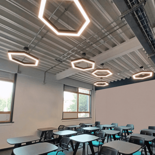 Multiple hexagon pendant lights installed within a classroom.