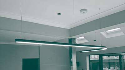 A stylish kitchen with ambient lighting and stylish track lighting above the kitchen table.