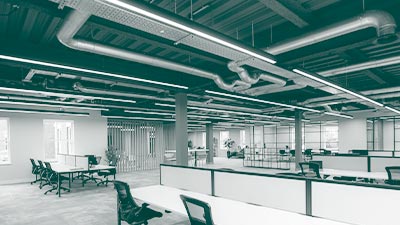 Linear lighting installed in an office above desks.