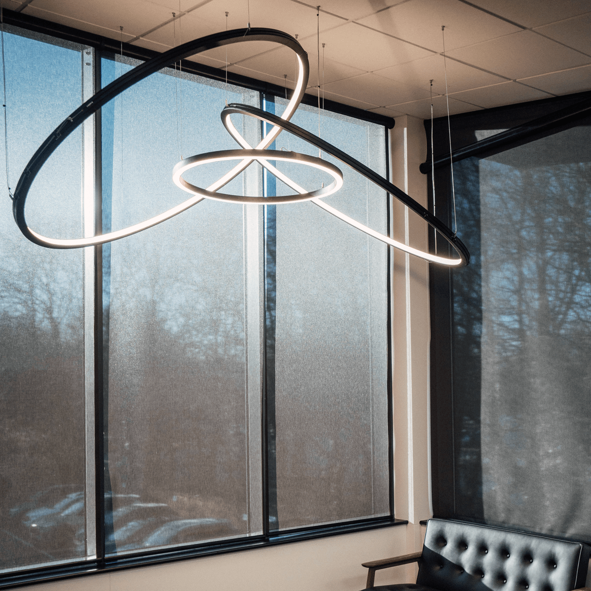 A bespoke halo ring led ceiling fitting in an office meeting room.