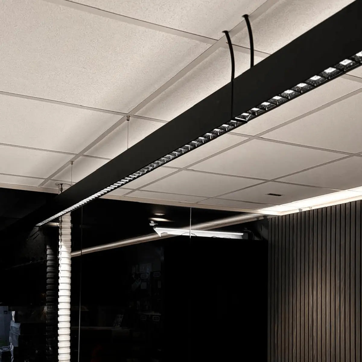 Square optics on an extra long black linear led light for an excellent UGR rating.