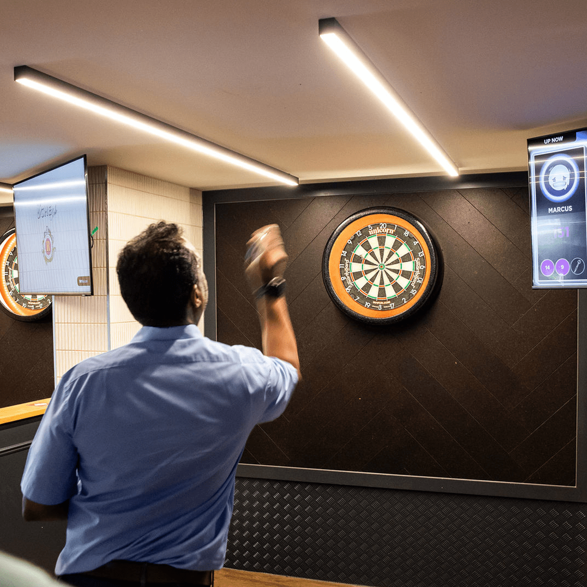 Straight linear ceiling mounted lights made bespoke for a darts room.