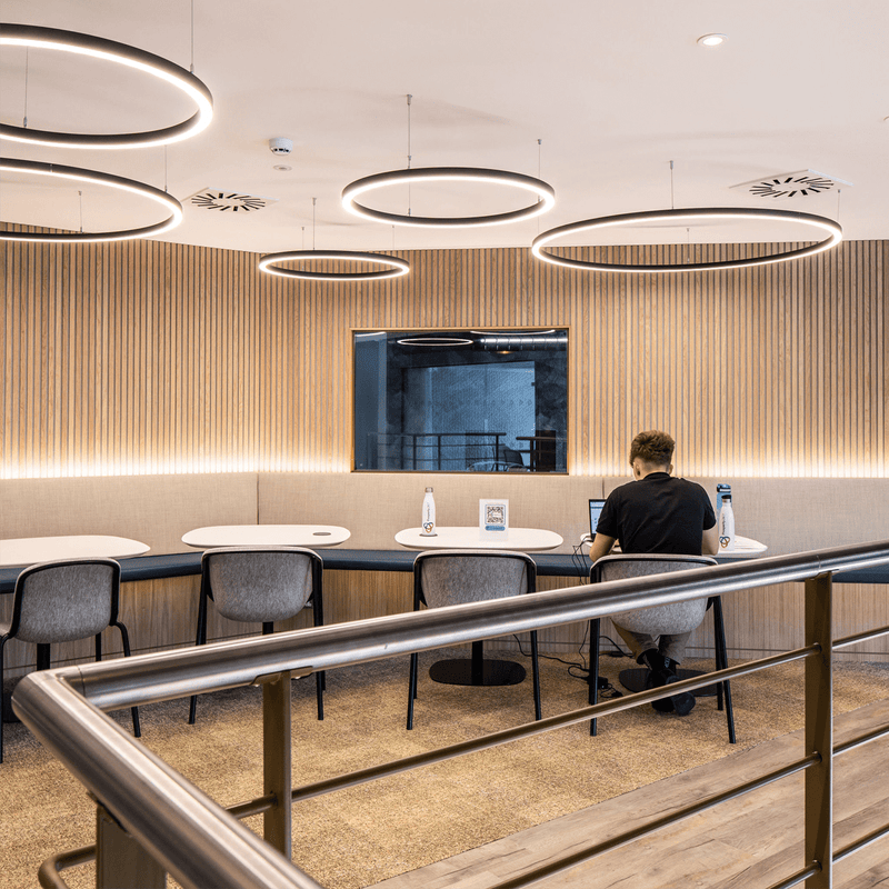 Large halo LED Pendant Lights in a modern cafe.