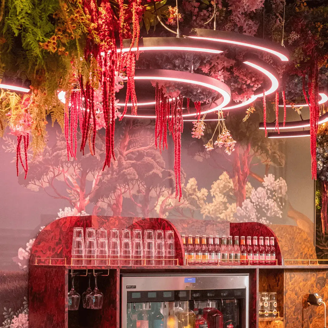 A bespoke curved lighting system that was installed in a restaurant adorn with biophilic elements.
