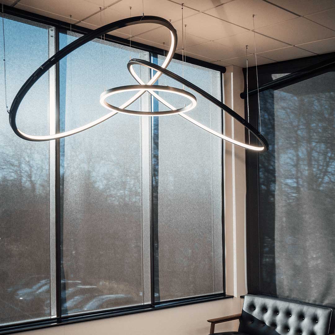 Bespoke lighting design using circular LED lights with inwards and downwards lighting.