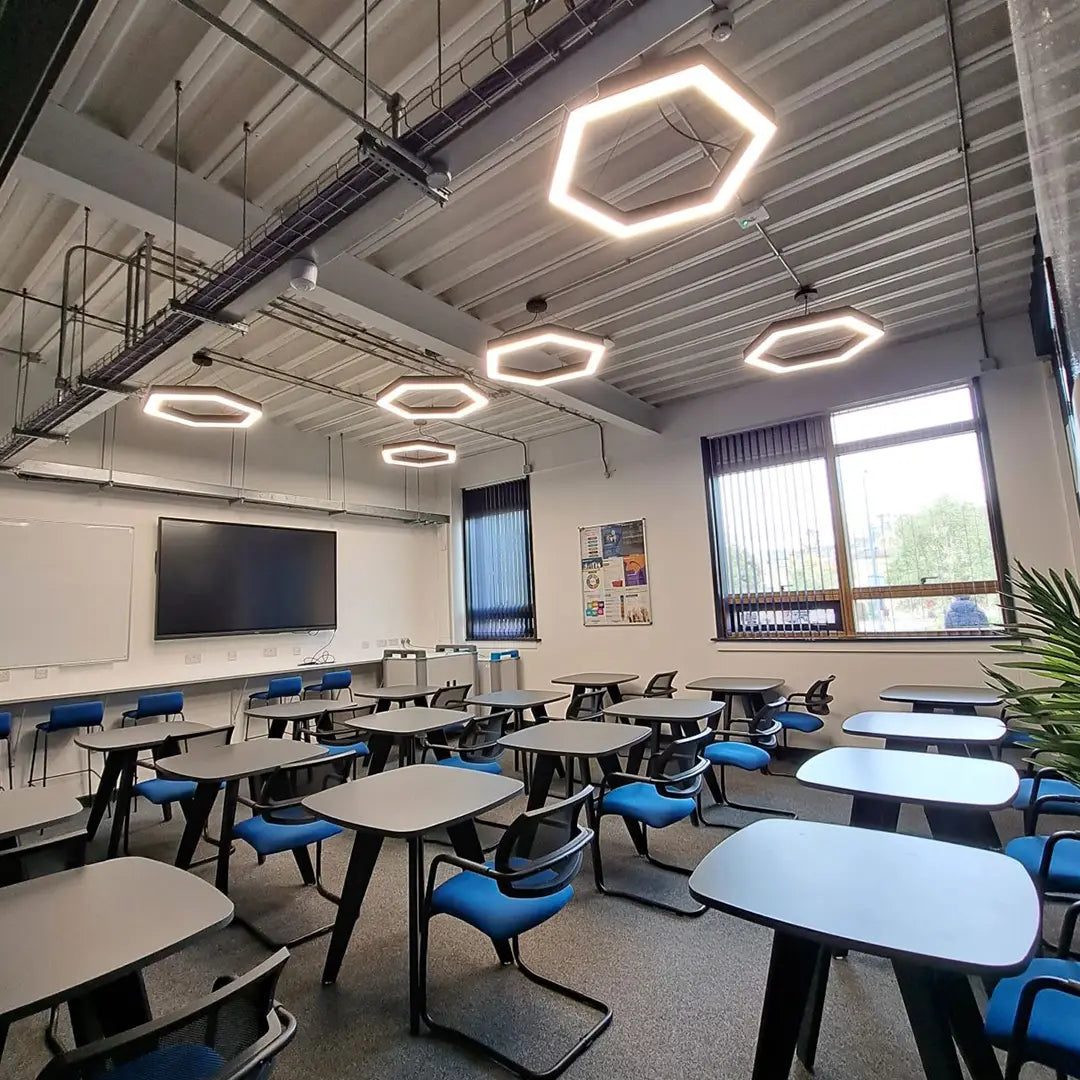 Hexagon led suspended lights installed within a classroom.