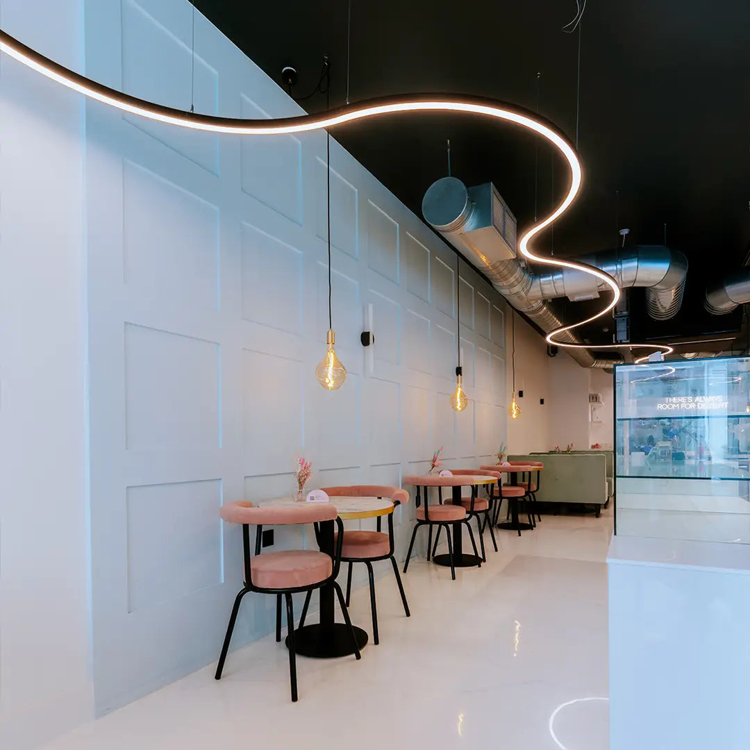 Modern restaurant interior with flowing decorative linear lighting that has been custom made.